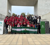 Jóvenes estudiantes y responsables de la Junta de Andalucía on la bandera de Andalucía